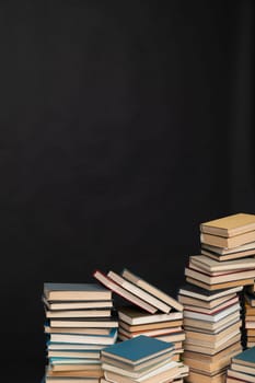 learning literacy science education stack of books on black background