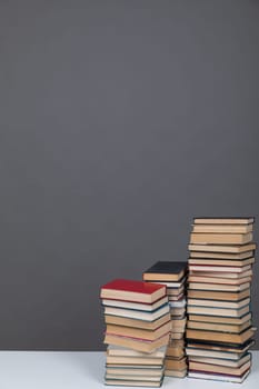a science education stack of books on grey background learning literacy
