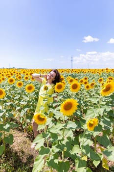 a woman brunette in sunflowers in the field nature travel walk