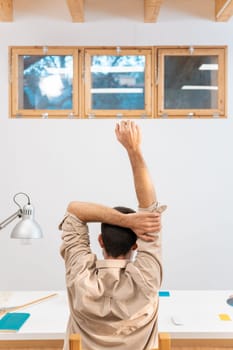 Young man stretching his spine at home. High quality photo