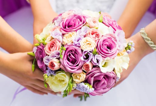 Beautiful wedding bouquet in hands of the bride.