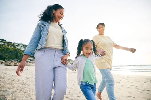 Happy, family and holding hands at the beach while walking for freedom, travel and holiday by the sea. Smile, care and a mother, grandmother and child at the ocean for bonding, vacation or together.