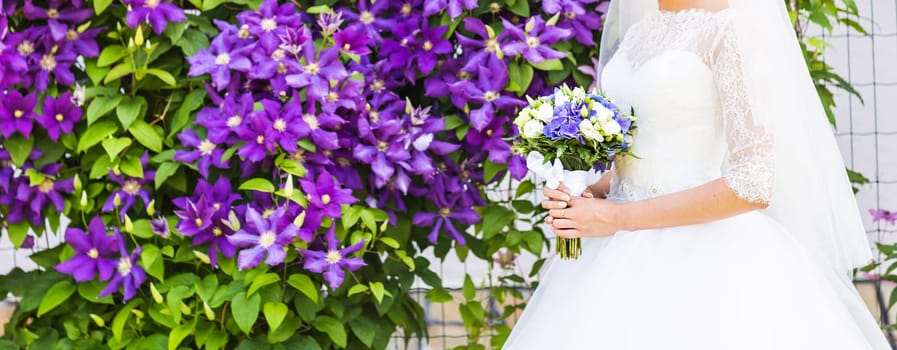 Beautiful wedding bouquet in hands of the bride.