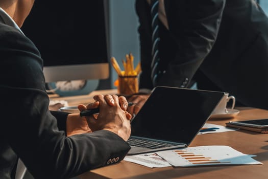 Smart businessman and businesswoman talking discussion in group meeting at office table in a modern office interior. Business collaboration strategic planning and brainstorming of coworkers. Jivy