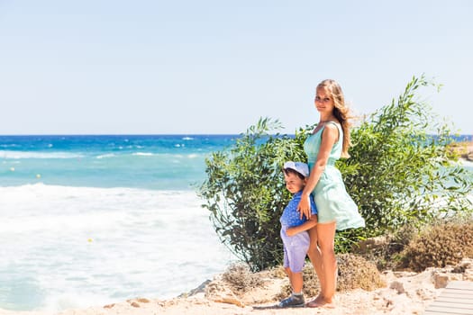 Portrait of happy mother and son at sea, outdoor.