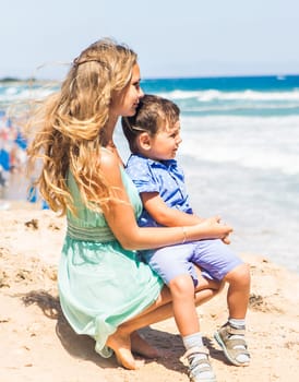 Loving mother and son hugging outdoors on beautiful summer day