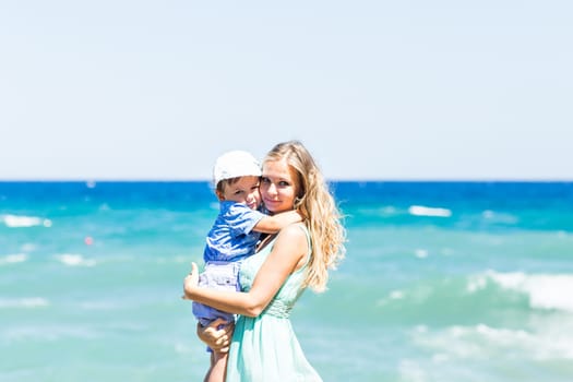 Portrait of happy mother and son at sea, outdoor.