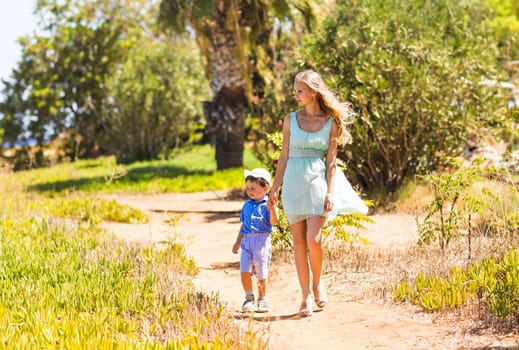 mother and son walking on nature outdoors