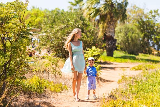 mother and son walking on nature outdoors