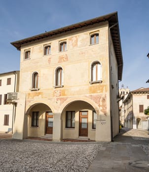 Portobuffolè, Italy. November 9, 2023. an old medieval palace with frescoes on the walls in the center of the city