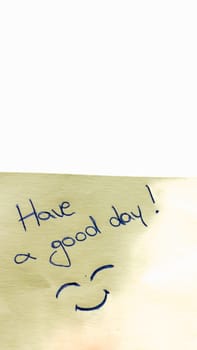 Have a good day handwriting text close up isolated on yellow paper with copy space.