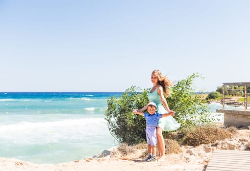 Portrait of happy mother and son at sea, outdoor.