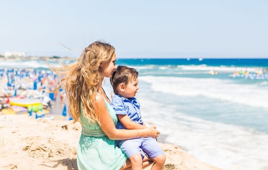 Portrait of happy mother and son at sea, outdoor.