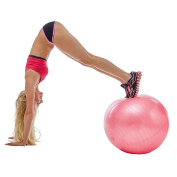 Image of energetic girl doing handstand on fitness ball