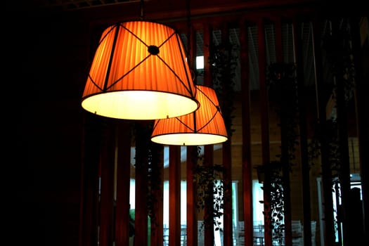 Photo for a lampshade in a dark room. Dimmed Lights. Cafe. Interior.