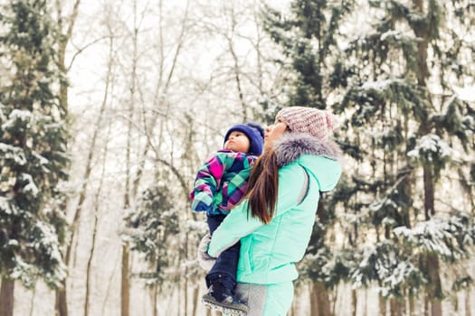 Little girl and her mom having fun on a winter day.