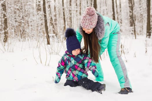 Portrait of happy mother and baby in winter park