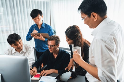 Group of diverse office worker employee working together on strategic business marketing planning in corporate office room. Positive teamwork in business workplace concept. Prudent