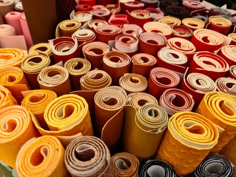 Samples of cloth and fabrics in different colors found at a fabrics market.