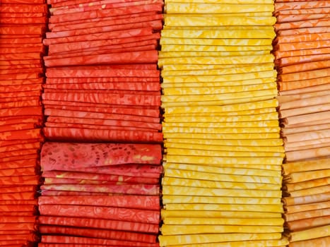 Samples of cloth and fabrics in different colors found at a fabrics market.