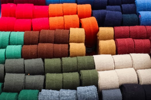 Samples of cloth and fabrics in different colors found at a fabrics market.