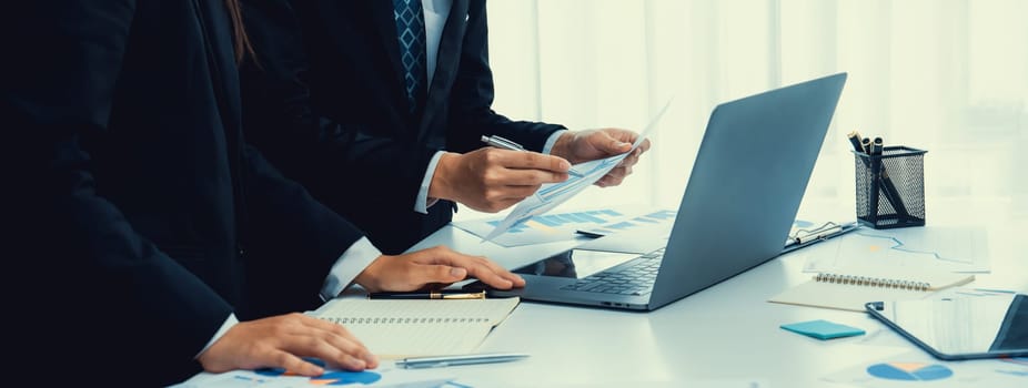 Business people in group meeting in formal attire share idea discussing report for company profit in creative workspace for start up business shot in close up view on group meeting table . Oratory .