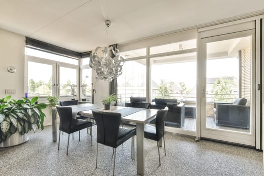 a dining room with chairs and a table in front of the sliding glass door that leads to an outdoor patio