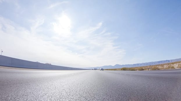 Embarking on a road trip from Nevada to California, driving on Highway 15 during the day offers scenic views and an exciting journey between states.