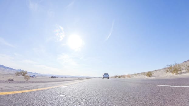 Embarking on a road trip from Nevada to California, driving on Highway 15 during the day offers scenic views and an exciting journey between states.