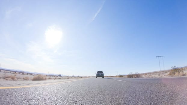 Embarking on a road trip from Nevada to California, driving on Highway 15 during the day offers scenic views and an exciting journey between states.