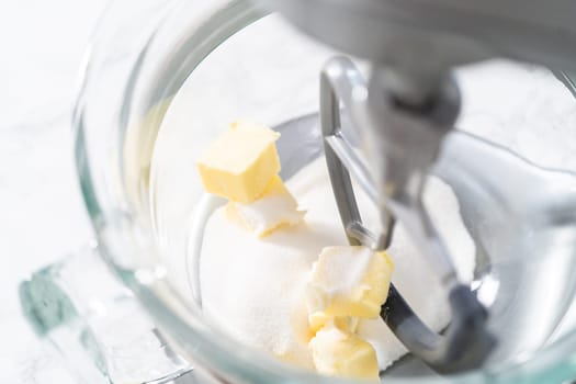 Mixing ingredients in kitchen electric mixer to bake American flag mini cupcakes.