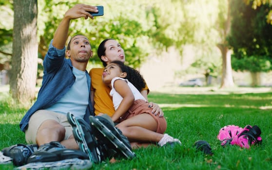 Interracial parents selfie, girl and park with funny face, rollerskate and family profile picture, happy or holiday. Black man, mother and kid for relax, hug and diversity for social network photo.