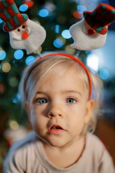 Surprised little girl in a New Year hoop. Portrait. High quality photo