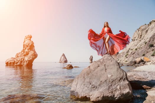 Woman travel sea. Happy tourist taking picture outdoors for memories. Woman traveler looks at the edge of the cliff on the sea bay of mountains, sharing travel adventure journey.