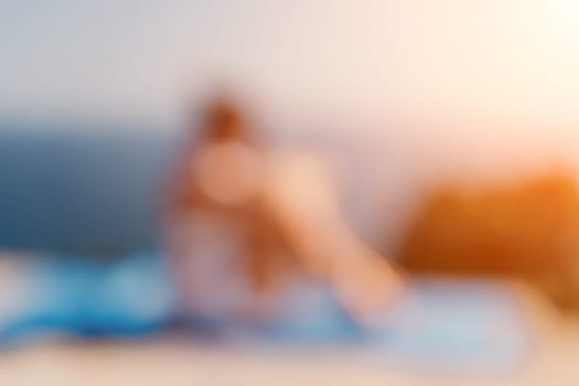 Fitness woman sea. Outdoor workout on yoga mat in park near to ocean beach. Female fitness pilates yoga routine concept. Healthy lifestyle. Happy fit woman exercising with rubber band in park.