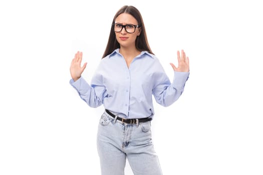 young successful european business lady with long black hair is wearing a blue blouse.