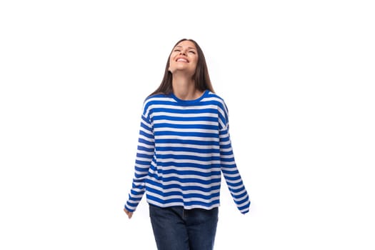 pretty slender brunette with straight hair is dressed in blue striped sailor clothes.