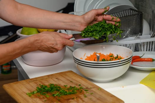 woman cutting parsley on a cutting board in the kitchen 8