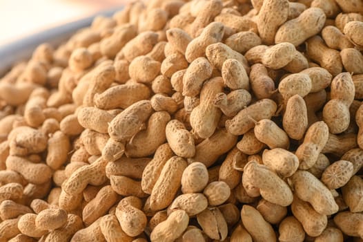 peanuts in pods piled in a pile at the local market