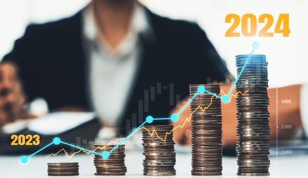 Growth coin stack symbolizing business investment and economic growth. Business people doing financial planning to achieve financial goal and contribute maximum profit on new year 2024 . Shrewd