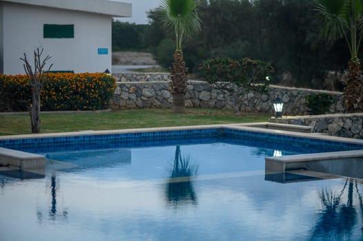 swimming pool near a house in a residential complex at sunset 2