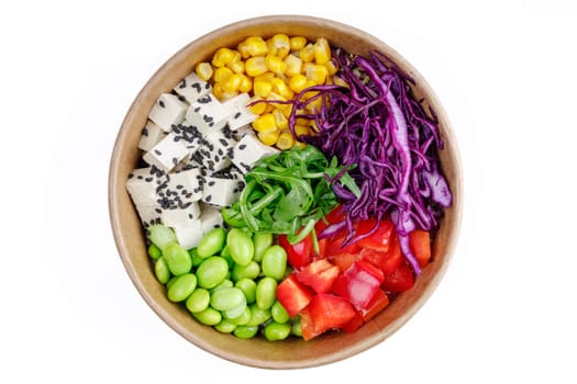 Bowl of tofu and quinoa, bulgur, corn, red cabbage, bell pepper, edamame beans, arugula, black sesame on a white background