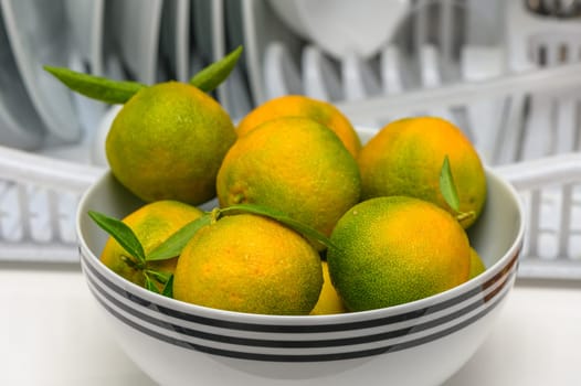 delicious fresh green-orange tangerines in a light plate 6