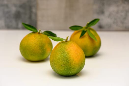 delicious fresh green-orange tangerines on a white background 1
