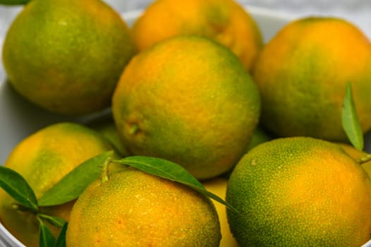 delicious fresh green-orange tangerines as background