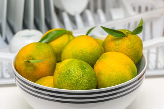 delicious fresh green-orange tangerines in a light plate 1