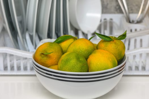 delicious fresh green-orange tangerines in a light plate