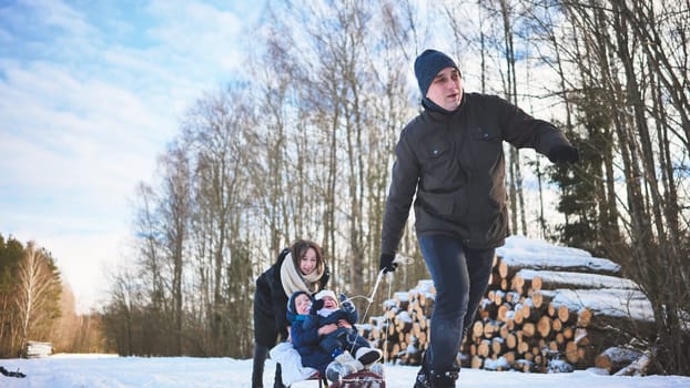 A happy family sledding in the woods