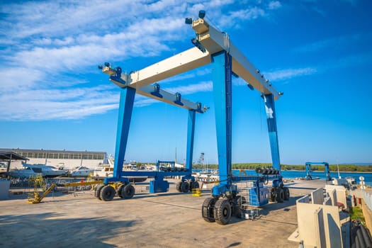 Large shipyard crane in yachting marina view, Krk island of Croatia