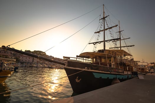 Mali Losinj harbor historic wooden sailboat sunset view, Island of Losinj, archipelago of Croatia